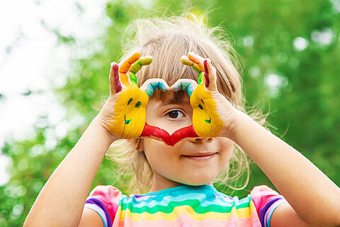 children hands in colors. Summer photo. Selective focus.