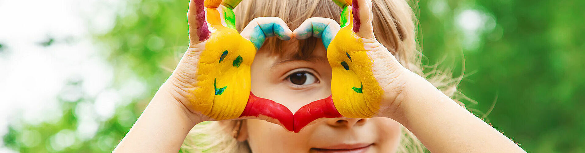 children hands in colors. Summer photo. Selective focus.